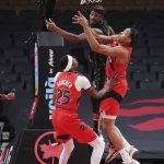 
              Miami Heat forward Jimmy Butler (22) and Toronto Raptors forward Scottie Barnes (4) jump for a rebound as Raptors forward Chris Boucher (25) watches during the first half of an NBA basketball game Tuesday, Feb. 1, 2022, in Toronto. (Nathan Denette/The Canadian Press via AP)
            
