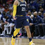 
              Memphis Grizzlies guard Tyus Jones (21) signals a 3-point basket against the New Orleans Pelicans during the second half of an NBA basketball game in New Orleans, Tuesday, Feb. 15, 2022. (AP Photo/Matthew Hinton)
            