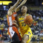 
              Michigan guard Frankie Collins (10) drives to the basket against Illinois guard Andre Curbelo, left, during the second half of an NCAA college basketball game Sunday, Feb. 27, 2022, in Ann Arbor, Mich. (AP Photo/Duane Burleson)
            