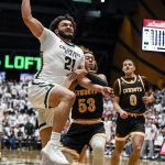 
              Wyoming's Xavier DuSell (53) fouls Colorado State's David Roddy (21) during the first half of an NCAA college basketball game Wednesday, Feb. 23, 2022 in Fort Collins, Colo. (AAron Ontiveroz/The Denver Post via AP)
            