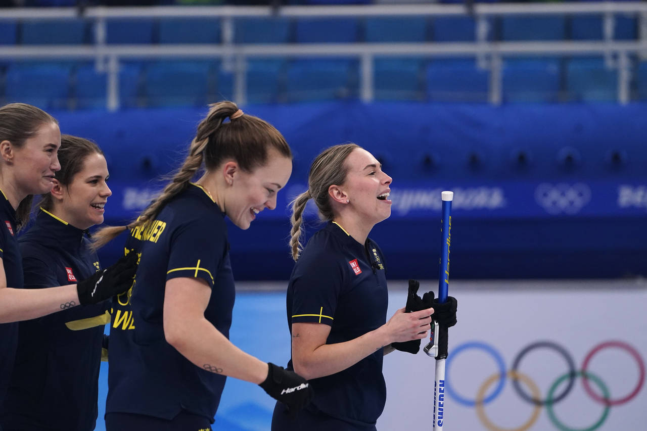 Team Sweden celebrates after winning the women's curling bronze medal match between Sweden and Swit...