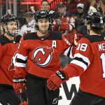 
              New Jersey Devils center Jack Hughes (86) celebrates his goal against the Vancouver Canucks with center Dawson Mercer (18) and defenseman Dougie Hamilton (7) during the first period of an NHL hockey game Monday, Feb. 28, 2022, in Newark, N.J. (AP Photo/Bill Kostroun)
            