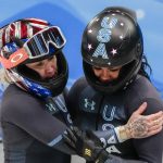 
              Kaillie Humphries and Kaysha Love, of the United States, celebrate after the women's bobsleigh heat 4 at the 2022 Winter Olympics, Saturday, Feb. 19, 2022, in the Yanqing district of Beijing. (AP Photo/Pavel Golovkin)
            