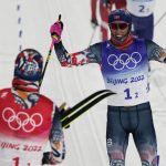 
              Johannes Hoesflot Klaebo, of Norway, right, celebrates a gold medal finish with Erik Valnes, of Norway, left, during the men's team sprint classic cross-country skiing competition at the 2022 Winter Olympics, Wednesday, Feb. 16, 2022, in Zhangjiakou, China. (AP Photo/Alessandra Tarantino)
            
