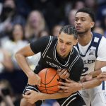 
              Providence's Brycen Goodine (12) is defended by Butler's Aaron Thompson (2) during the first half of an NCAA college basketball game, Sunday, Feb. 20, 2022, in Indianapolis. (AP Photo/Darron Cummings)
            