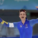 
              Nils van der Poel of Sweden celebrates after winning the gold medal and setting an Olympic record in the men's speedskating 5,000-meter race at the 2022 Winter Olympics, Sunday, Feb. 6, 2022, in Beijing.(AP Photo/Ashley Landis)
            