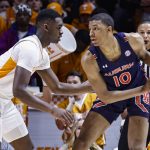
              Auburn forward Jabari Smith (10) works for a shot as he is defended by Auburn guard K.D. Johnson (0) during the first half of an NCAA college basketball game Saturday, Feb. 26, 2022, in Knoxville, Tenn. (AP Photo/Wade Payne)
            