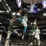 
              Charlotte Hornets' Terry Rozier shoots past Milwaukee Bucks' Bobby Portis and Javon Carter during the first half of an NBA basketball game Monday, Feb. 28, 2022, in Milwaukee. (AP Photo/Morry Gash)
            