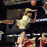 
              Vanderbilt guard Tyrin Lawrence (0) is fouled by Alabama forward James Rojas, bottom, during the first half of an NCAA college basketball game Tuesday, Feb. 22, 2022, in Nashville, Tenn. (AP Photo/Mark Zaleski)
            