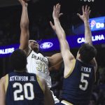 
              Wake Forest's Alondes Williams sinks a basket over Notre Dame's Cormac Ryan in the closing minute of Wake Forest's 79-74 win in an NCAA college basketball game, Saturday, Feb. 19, 2022, at Joel Coliseum in Winston-Salem, N.C. (Walt Unks/The Winston-Salem Journal via AP)
            