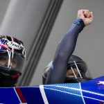 
              Elana Meyers Taylor and Sylvia Hoffman, of the United States, celebrate winning the bronze medal in the women's bobsleigh at the 2022 Winter Olympics, Saturday, Feb. 19, 2022, in the Yanqing district of Beijing. (AP Photo/Mark Schiefelbein)
            