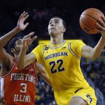 
              Michigan forward Caleb Houstan (22) goes to the basket against Illinois guard Jacob Grandison (3) during the second half of an NCAA college basketball game Sunday, Feb. 27, 2022, in Ann Arbor, Mich. (AP Photo/Duane Burleson)
            