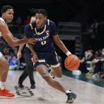
              Notre Dame guard Blake Wesley (0) drives past Miami guard Charlie Moore during the first half of an NCAA college basketball game, Wednesday, Feb. 2, 2022, in Coral Gables, Fla. (AP Photo/Wilfredo Lee)
            