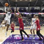 
              Northwestern's Elyjah Williams (21) shoots over Nebraska's Quaran Mcpherson during the first half of an NCAA college basketball game Tuesday, Feb. 22, 2022, in Evanston, Ill. (AP Photo/Charles Rex Arbogast)
            