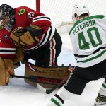 
              Chicago Blackhawks goaltender Marc-Andre Fleury, left, gives up a goal to Dallas Stars center Jacob Peterson during the shootout in an NHL hockey game in Chicago, Friday, Feb. 18, 2022. The Stars won 1-0. (AP Photo/Nam Y. Huh)
            