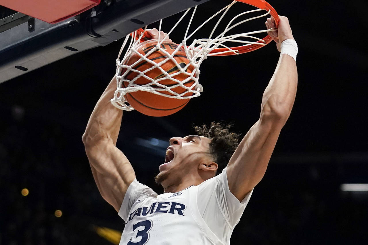 Xavier guard Colby Jones dunks during the first half of the team's NCAA college basketball game aga...