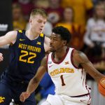 
              Iowa State guard Izaiah Brockington (1) drives past West Virginia guard Sean McNeil (22) during the second half of an NCAA college basketball game, Wednesday, Feb. 23, 2022, in Ames, Iowa. Iowa State won 84-81. (AP Photo/Charlie Neibergall)
            