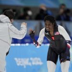 
              Erin Jackson of the United States reacts with coach Ryan Shimabukuro after winning the gold medal in the speedskating women's 500-meter race at the 2022 Winter Olympics, Sunday, Feb. 13, 2022, in Beijing. (AP Photo/Ashley Landis)
            