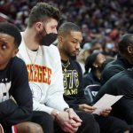 
              Portland Trail Blazers guard Damian Lillard, third from left, and center Jusuf Nurkic, second from left, look at a stat sheet while sitting on the bench during the second half of an NBA basketball game against the Denver Nuggets in Portland, Ore., Sunday, Feb. 27, 2022. (AP Photo/Craig Mitchelldyer)
            