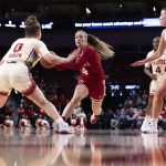 
              Indiana's Nicole Cardaño-Hillary (4) drives against Nebraska's Ashley Scoggin (0) and Isabelle Bourne (34) during the first half of an NCAA college basketball game Monday, Feb. 14, 2022, in Lincoln, Neb. (AP Photo/Rebecca S. Gratz)
            