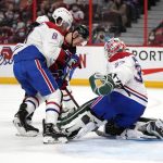 
              The puck rebounds as Montreal Canadiens goaltender Andrew Hammond (37), defenseman Ben Chiarot (8) and Ottawa Senators left wing Brady Tkachuk (7) search for it, during the second period of an NHL hockey game Saturday, Feb. 26, 2022 in Ottawa, Ontario. (Justin Tang/The Canadian Press via AP)
            