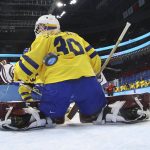 
              A shot by Japan gets past Sweden goalkeeper Emma Soderberg (30) for a score during a preliminary round women's hockey game at the 2022 Winter Olympics, Thursday, Feb. 3, 2022, in Beijing. (Jonathan Ernst/Pool Photo via AP)
            
