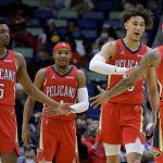 
              New Orleans Pelicans center Jaxson Hayes (10), second from right, celebrates an assist from forward Brandon Ingram (14) next to guard Devonte' Graham (4) and forward Herbert Jones (5), left, during the first half of an NBA basketball game against the Toronto Raptors in New Orleans, Monday, Feb. 14, 2022. (AP Photo/Matthew Hinton)
            