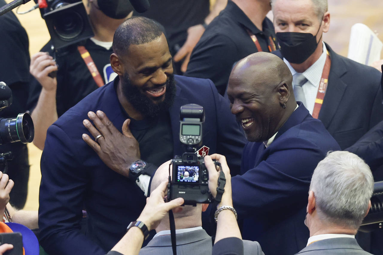 Los Angeles Lakers' LeBron James, left, and former NBA great Michale Jordan greet each other during...