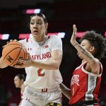 
              Maryland's Mimi Collins, left, looks to pass as Ohio State's Rikki Harris defends during the first half of an NCAA college basketball game Thursday, Feb. 17, 2022, in College Park, Md. (AP Photo/Gail Burton)
            