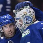 
              Vancouver Canucks' Brad Hunt, left, congratulates goalie Thatcher Demko after they defeated the Toronto Maple Leafs in an NHL hockey game in Vancouver, British Columbia, Saturday, Feb. 12, 2022. (Darryl Dyck/The Canadian Press via AP)
            