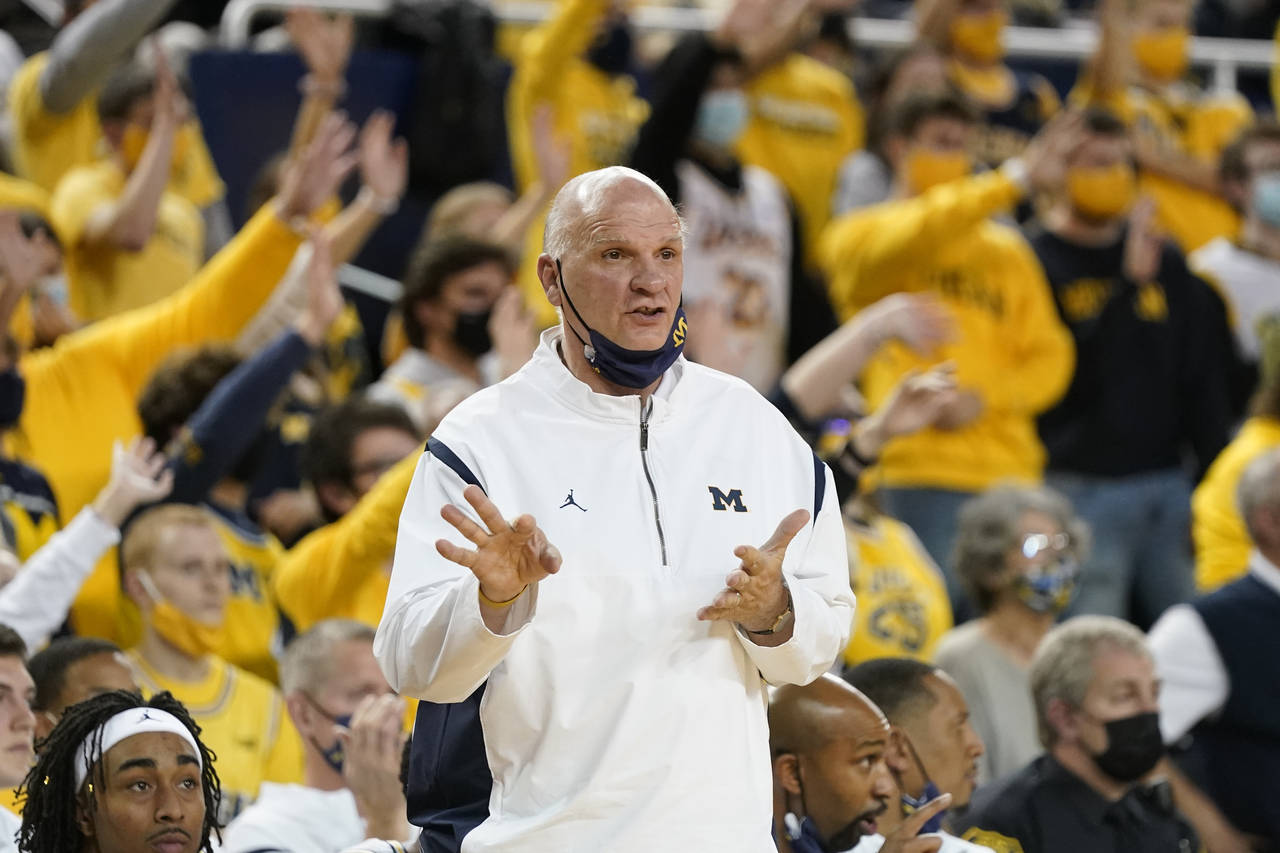 FILE - Michigan associate head coach Phil Martelli signals from the sideline during the second half...