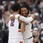 
              Connecticut's Tyler Polley and Isaiah Whaley, right, embrace at the end of the team's NCAA college basketball game against Villanova, Tuesday, Feb. 22, 2022, in Hartford, Conn. (AP Photo/Jessica Hill)
            