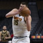 
              Denver Nuggets' Nikola Jokic grabs a rebound against the Toronto Raptors during the first half of an NBA basketball game, Saturday, Feb. 12, 2022 in Toronto. (Chris Young/The Canadian Press via AP)
            