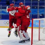 
              Russian Olympic Committee goalkeeper Ivan Fedotov, right, celebrates with Nikita Nesterov (89) and Yegor Yakovlev, left, after defeating Sweden in a shootout during a men's semifinal hockey game at the 2022 Winter Olympics, Friday, Feb. 18, 2022, in Beijing. (AP Photo/Matt Slocum)
            