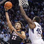 Gonzaga forward Anton Watson (22) goes to the basket as BYU forward Fousseyni Traore (45) defends during the first half of an NCAA college basketball game Saturday, Feb. 5, 2022, in Provo, Utah. (AP Photo/Rick Bowmer)