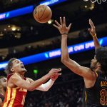 
              Atlanta Hawks guard Trae Young (11) loses control of the ball as he drives against Cleveland Cavaliers center Jarrett Allen (31) during the first half of an NBA basketball game Tuesday, Feb. 15, 2022, in Atlanta. (AP Photo/John Bazemore)
            