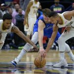 
              New Orleans Pelicans guard CJ McCollum, right, steals the ball from Dallas Mavericks guard Luka Doncic (77), next to New Orleans Pelicans forward Herbert Jones (5) during the second half of an NBA basketball game in New Orleans, Thursday, Feb. 17, 2022. (AP Photo/Matthew Hinton)
            