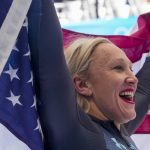 
              Kaillie Humphries, of the United States, celebrates winning the gold medal in the women's monobob at the 2022 Winter Olympics, Monday, Feb. 14, 2022, in the Yanqing district of Beijing. (AP Photo/Mark Schiefelbein)
            