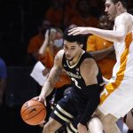 
              Vanderbilt guard Scotty Pippen Jr. (2) drives around Tennessee forward John Fulkerson, right, during the first half of an NCAA college basketball game Saturday, Feb. 12, 2022, in Knoxville, Tenn. (AP Photo/Wade Payne)
            