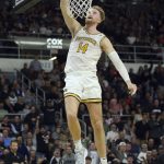 
              Providence's Noah Horchler (14) slam dunks the ball during the first half of an NCAA college basketball game against Xavier Wednesday, Feb. 23, 2022, in Providence, R.I. (AP Photo/Stew Milne)
            