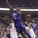 
              TCU guard Damion Baugh (10) drives past Texas forward Christian Bishop (32) and guard Courtney Ramey (3) during the first half of an NCAA college basketball game in Austin, Texas, Wednesday, Feb. 23, 2022. (AP Photo/Chuck Burton)
            