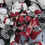 
              Russian Olympic Committee and Switzerland players fight as officials try to separate them during a preliminary round men's hockey game at the 2022 Winter Olympics, Wednesday, Feb. 9, 2022, in Beijing. (AP Photo/Matt Slocum)
            