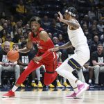 
              Texas Tech guard Adonis Arms (25) is defended by West Virginia forward Jalen Bridges, right, during the first half of an NCAA college basketball game in Morgantown, W.Va., Saturday, Feb. 5, 2022. (AP Photo/Kathleen Batten)
            