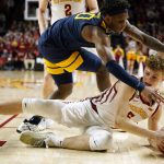 
              Iowa State forward Aljaz Kunc (5) fights for a loose ball with West Virginia guard Malik Curry (10) during the second half of an NCAA college basketball game, Wednesday, Feb. 23, 2022, in Ames, Iowa. (AP Photo/Charlie Neibergall)
            