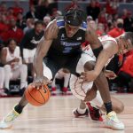 
              Memphis center Jalen Duren (2) recovers a loose ball as Houston forward Fabian White Jr., right, tries reaching in during the first half of an NCAA college basketball game Saturday, Feb. 12, 2022, in Houston. (AP Photo/Michael Wyke)
            