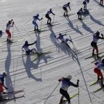 
              Skiers fall while competing during the women's 7.5km + 7.5km skiathlon cross-country skiing competition at the 2022 Winter Olympics, Saturday, Feb. 5, 2022, in Zhangjiakou, China. (AP Photo/John Locher)
            