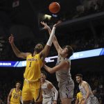
              Minnesota forward Eric Curry (1) and Northwestern center Ryan Young, front right, go after the ball during the first half of an NCAA college basketball game Saturday, Feb. 19, 2022, in Minneapolis. (AP Photo/Stacy Bengs)
            