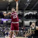 
              Indiana's Trayce Jackson-Davis (23) goes up for a dunk as Northwestern's Ryan Young (15) watches during the second half of an NCAA college basketball game Tuesday, Feb. 8, 2022, in Evanston, Ill. Northwestern won 59-51. (AP Photo/Charles Rex Arbogast)
            