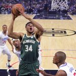 
              Milwaukee Bucks forward Giannis Antetokounmpo, second from right, shoots as Los Angeles Clippers center Serge Ibaka, right, defends during the first half of an NBA basketball game Sunday, Feb. 6, 2022, in Los Angeles. (AP Photo/Mark J. Terrill)
            