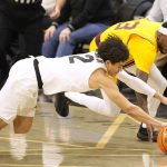 
              Colorado guard KJ Simpson, front, and Arizona State guard Marreon Jackson scramble for the ball during the first half of an NCAA college basketball game Thursday, Feb. 24, 2022, in Boulder, Colo. (AP Photo/David Zalubowski)
            